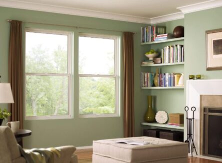 Interior of a living room featuring white single hung windows.